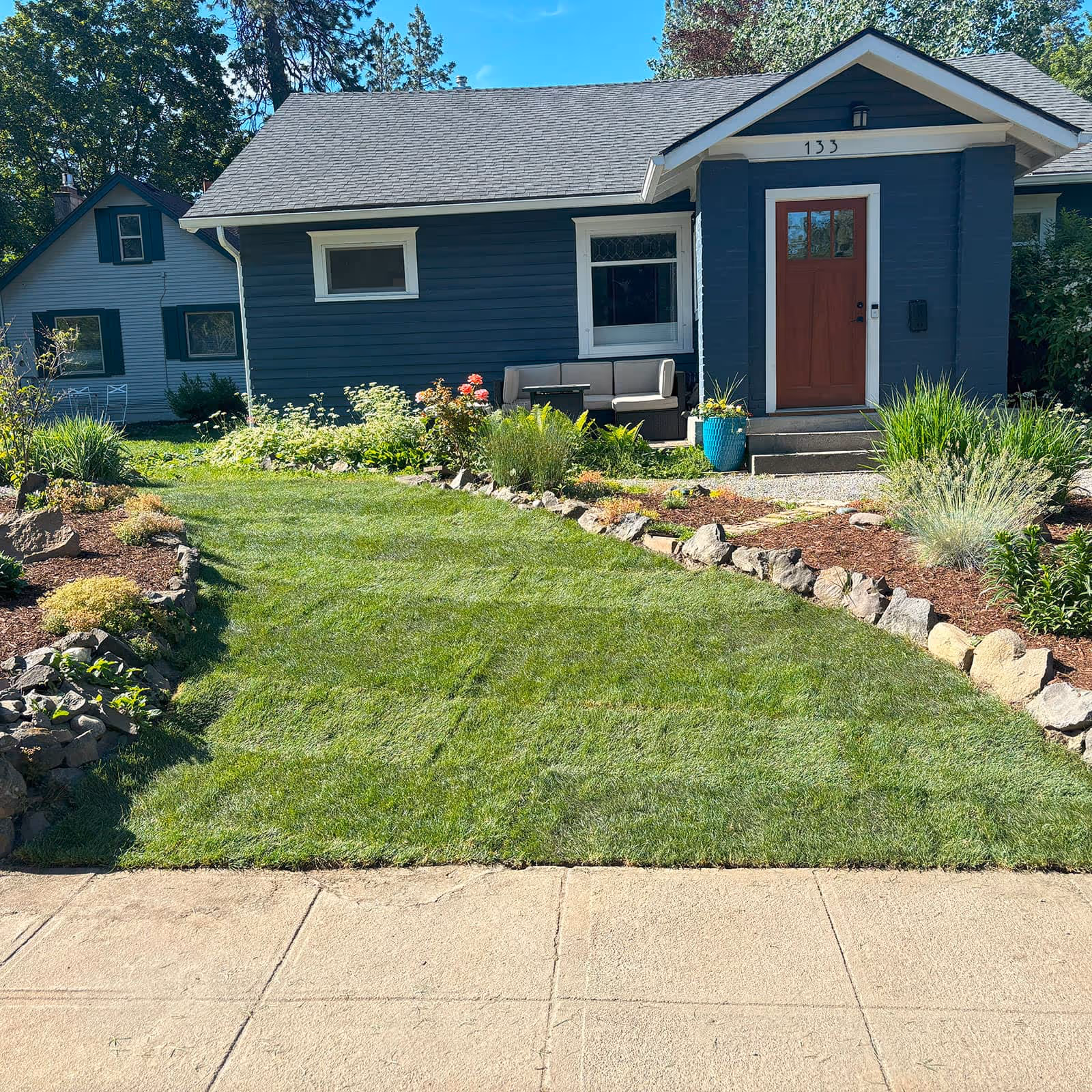 Decorative rock installation around foundation